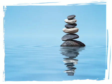 Steinbalance im Wasser als Symbol für innere Klarheit und Gleichgewicht beim VIP-Coaching-Tag